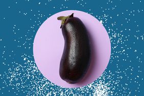 An eggplant in a photo composite with a background covered in salt.