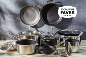 A variety of non-stick cookware displayed on a marble surface