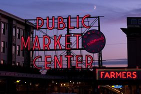 A neon sign for Public Market Center in Seattle at dusk