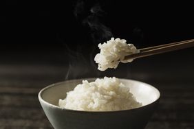 Cooked rice and chopsticks.