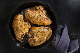 Grilled chicken breasts in a cast iron pan.