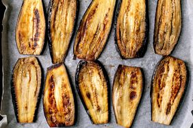 Sliced grilled eggplants on baking paper. 