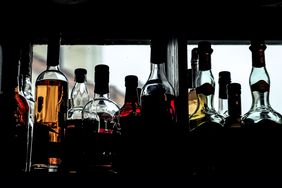 Liquor bottles in a window.