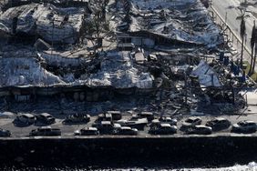 LAHAINA, HAWAII - AUGUST 11: In an aerial view, cars destroyed by wildfire line Front Street on August 11, 2023 in Lahaina, Hawaii. Dozens of people were killed and thousands were displaced after a wind-driven wildfire devastated the town of Lahaina on Tuesday. 