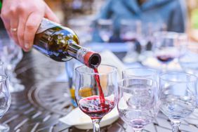 Red wine being poured into a glass. 