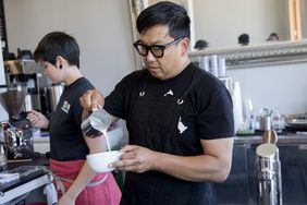 Wrecking Ball Coffee founder and owner Nick Cho works behind the counter to create drinks at his shop along Shattuck Avenue in Berkeley, Calif.