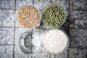 Schleswig-Holstein, Flensburg: Vessels with malt (top, l), hops (top, r), water (bottom, l), and yeast, the four ingredients for beer, stand on the floor in the brewhouse of the Flensburg brewery. The German Purity Law is one of the oldest food regulations in the world and has been in force for around 500 years. 