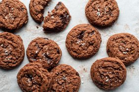 Close up of salted dark chocolate cookies on parchment paper.