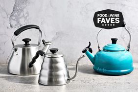 A side-by-side selection of stovetop kettles sitting on a table