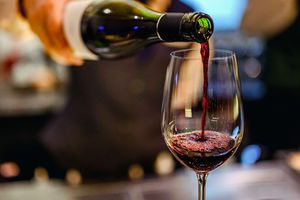 A bartender pours a glass of Cabernet Sauvignon